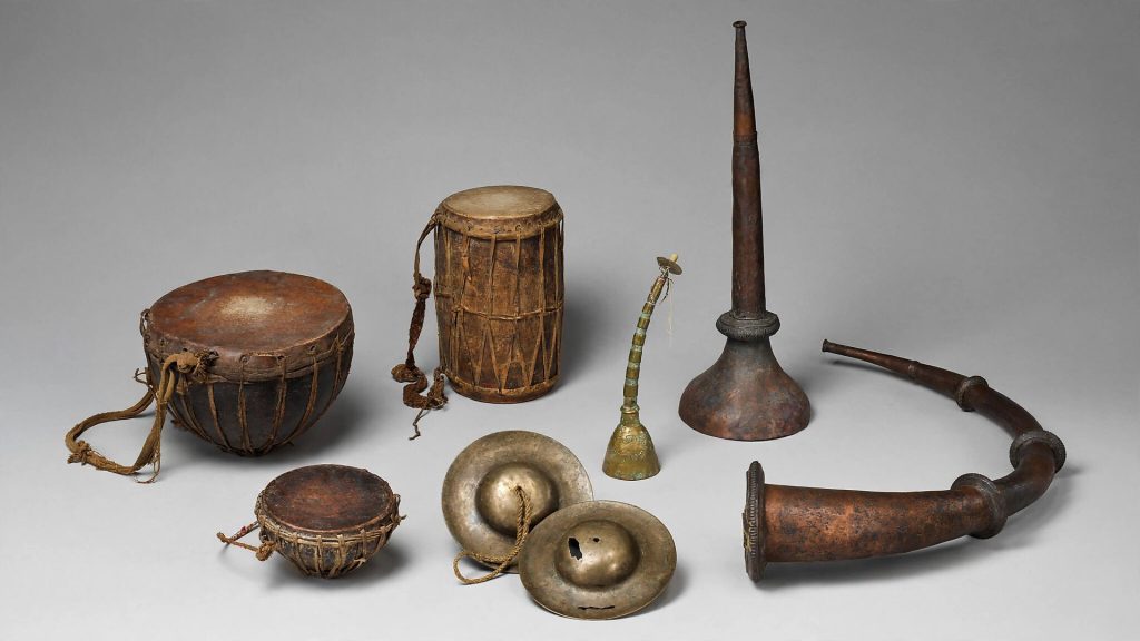 Close-up of traditional Nepali instruments including Damaha kettledrum and Jhyali