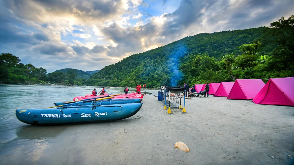 Riverside camp with tents on a sandy beach along the Trishuli River