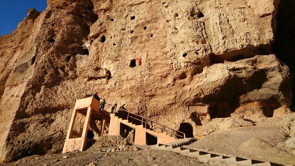 Multi-storey cave entrances at Chhoser reached by a stone path from the village below