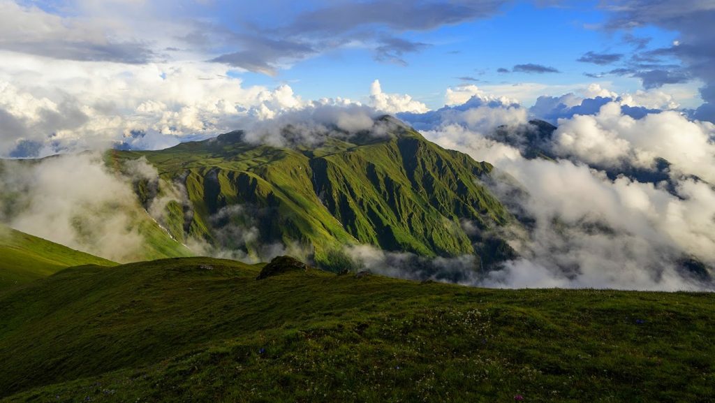 Green terraced hillsides and low cloud in the Nepali mid hills during the monsoon